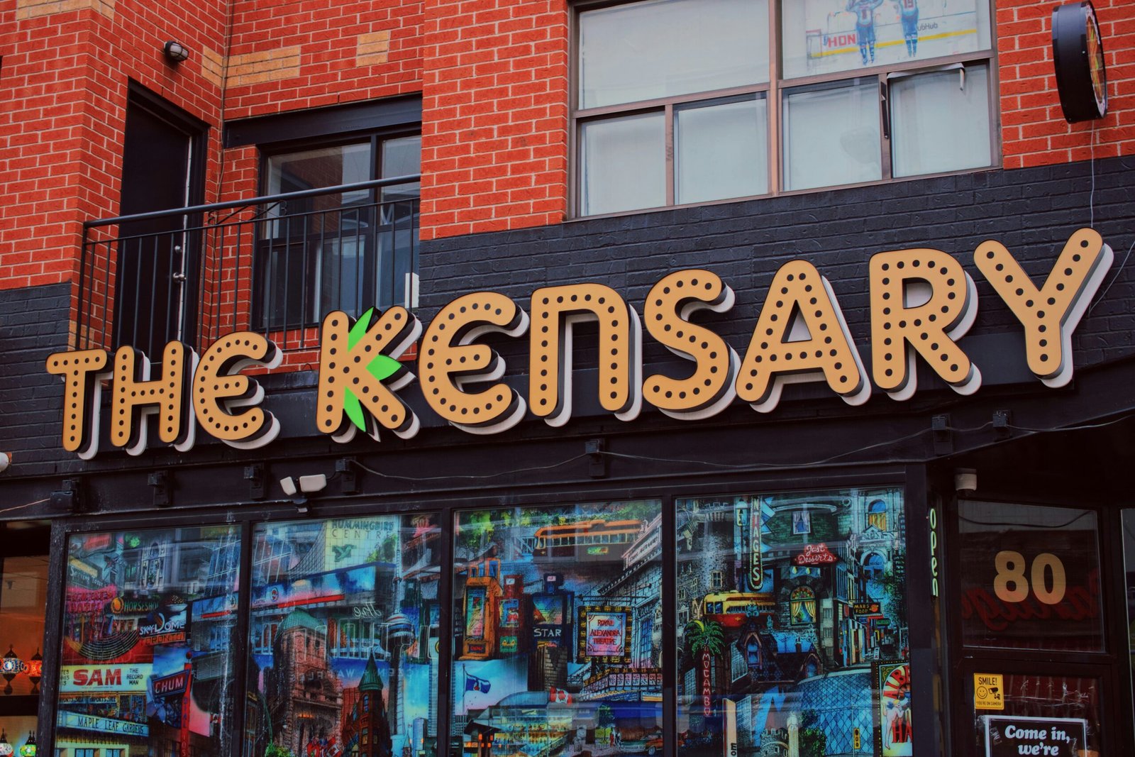 a store front with a large neon sign above it